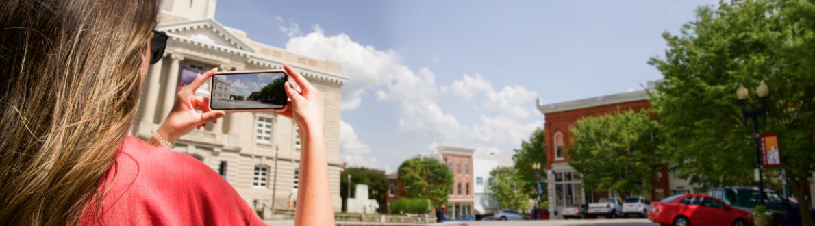 Woman taking photo of courthouse